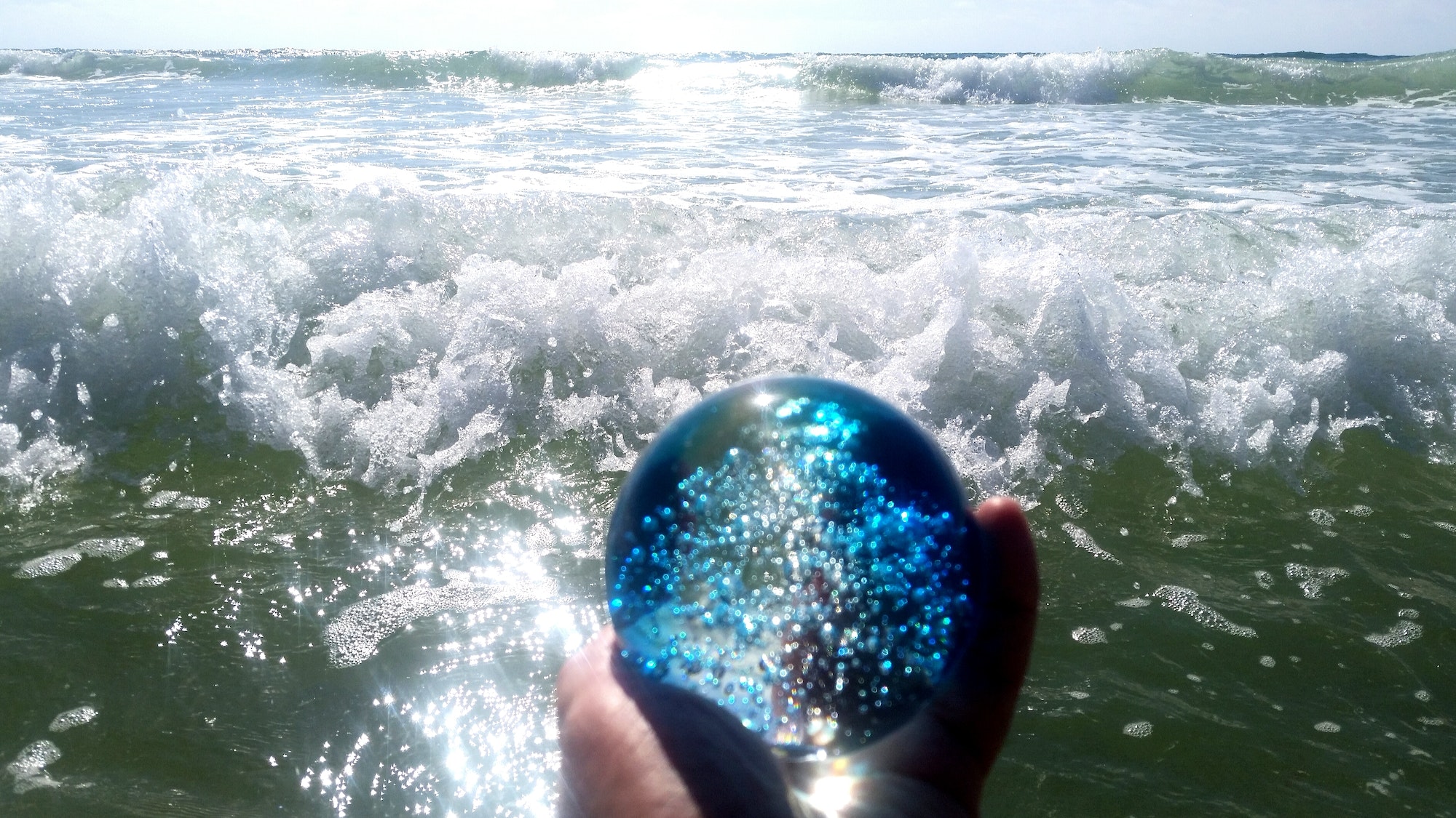 A blue crystal ball with bubbles forecasts many more ocean waves in the future.