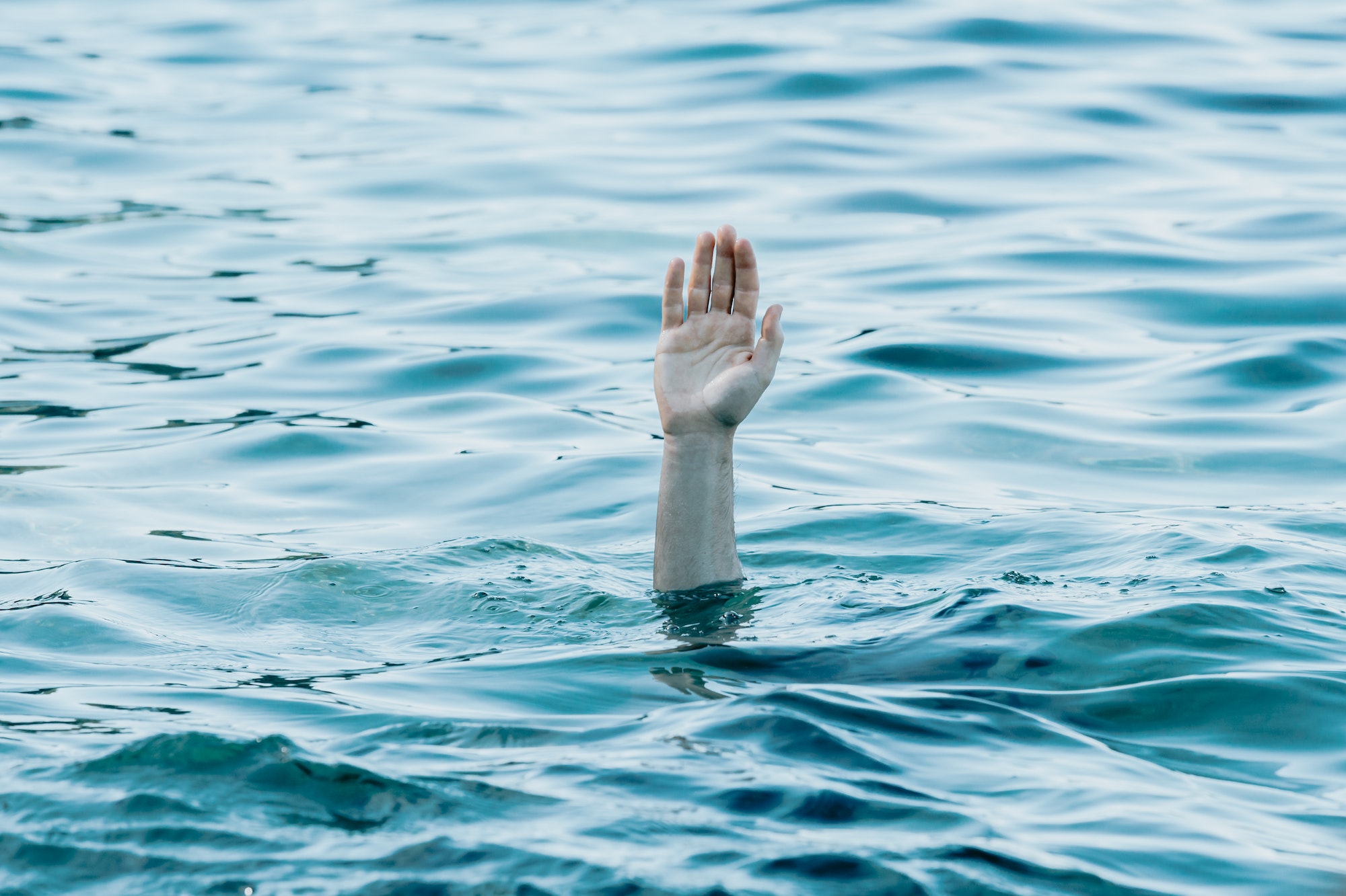 A hand showing out the ocean, rescue and help concept, self care, drown anxiety