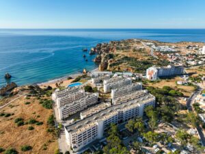 Drone view of Algarve cliffs and Lagos beachfront apartments