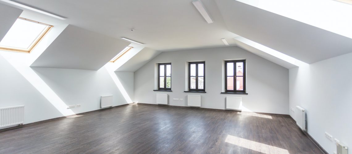 Side view of unfurnished room interior with wooden floor on roof floor, white walls